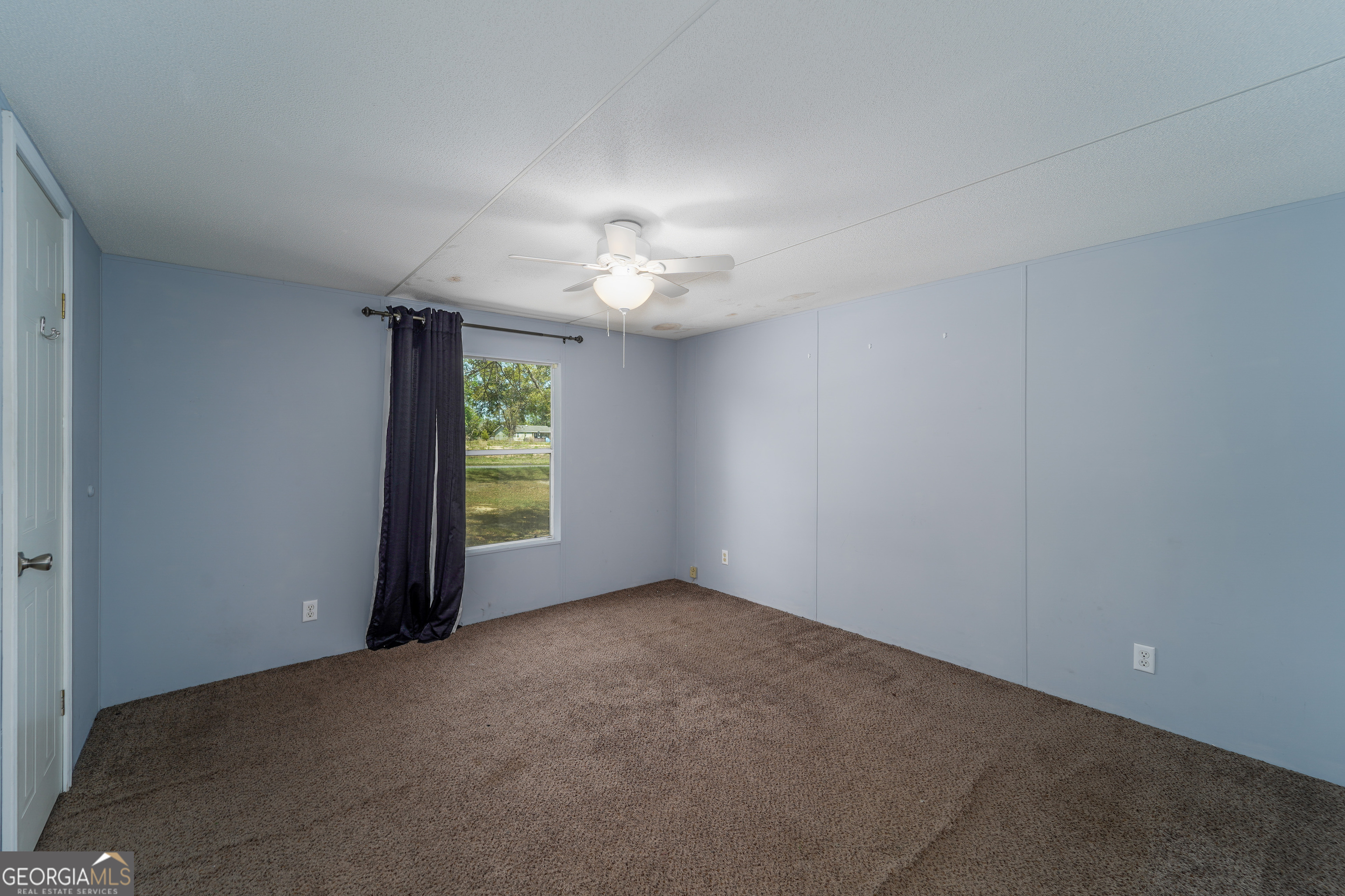 3642 Tanner Lane Waycross, GA 31503 - Photo 33 of 36 an empty room with windows and fan