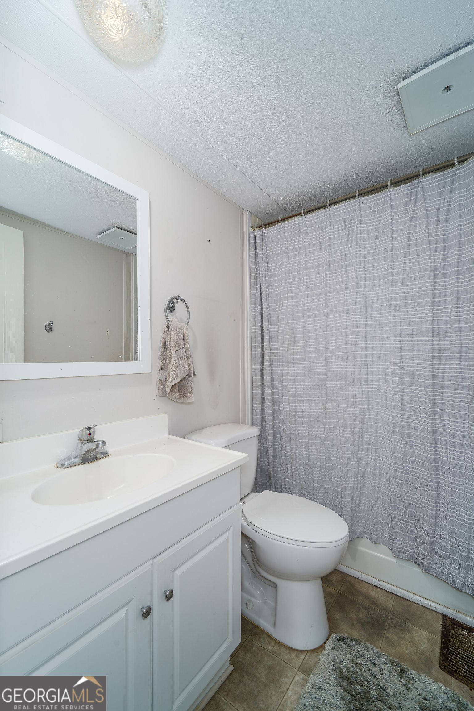 3642 Tanner Lane Waycross, GA 31503 - Photo 35 of 36 a bathroom with a sink a toilet and shower