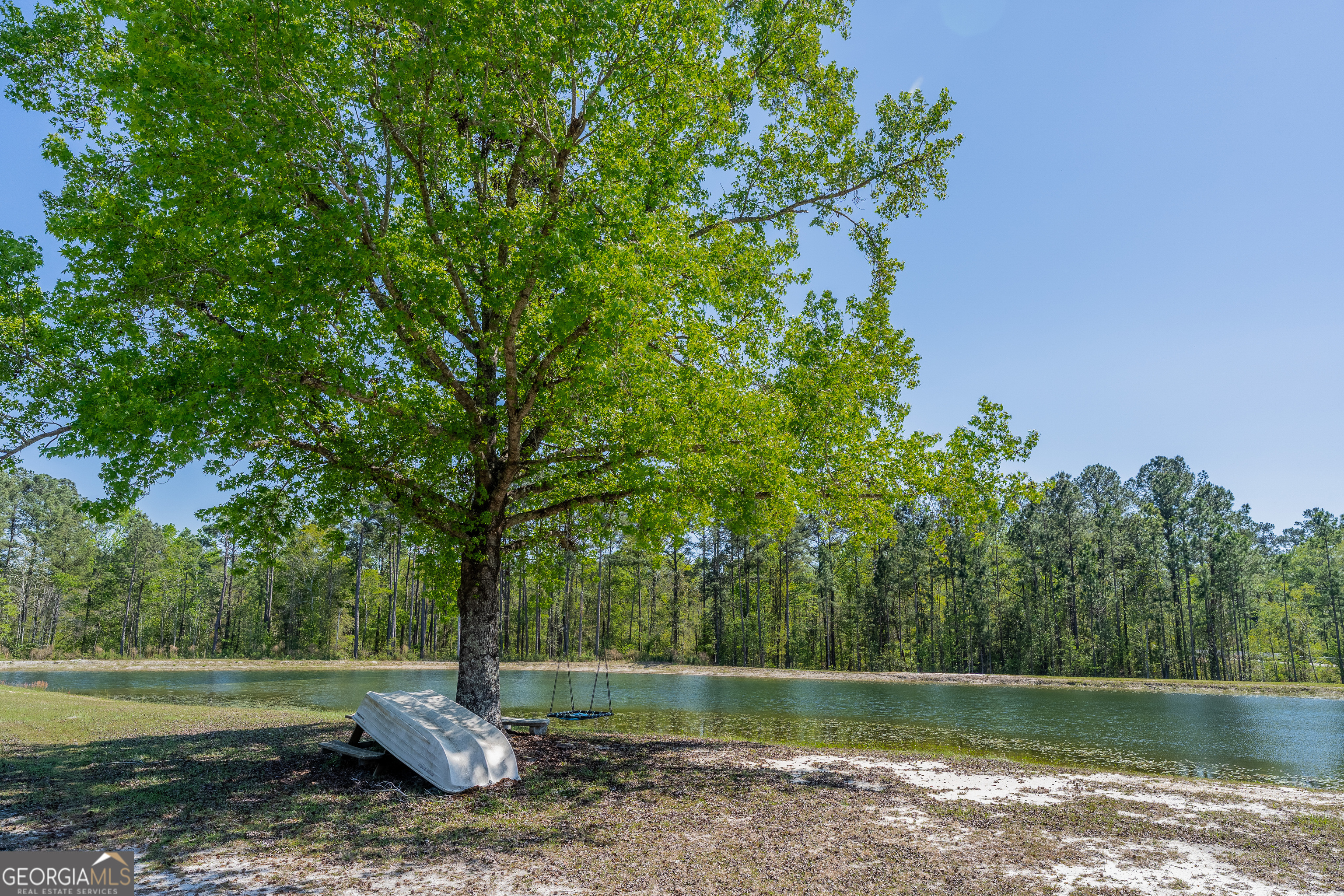 3642 Tanner Lane Waycross, GA 31503 - Photo 10 of 36 a backyard of a house with lots of green space and lake view