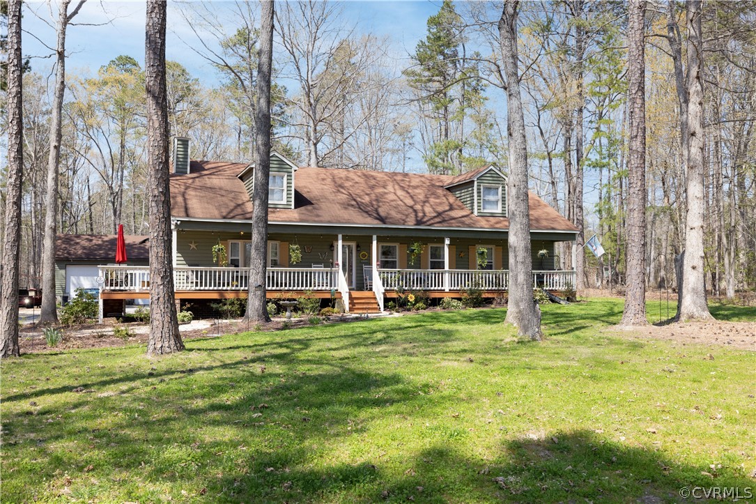 a view of a house with a yard and sitting area