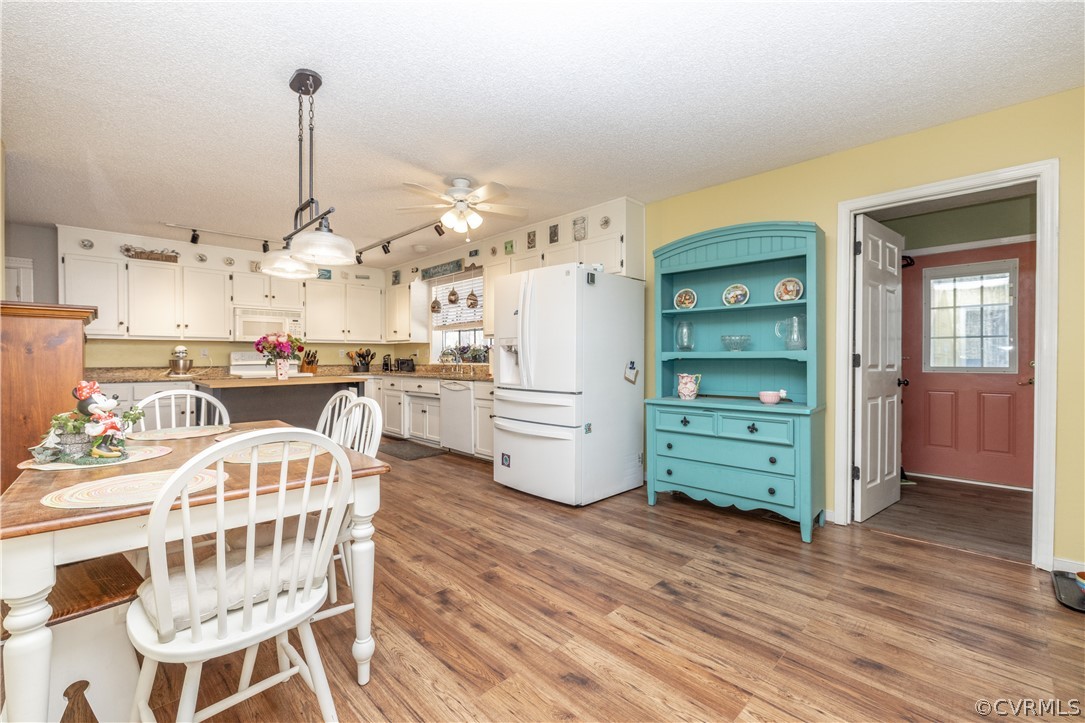 18920 Duval Road Moseley, VA 23120 - Photo 13 of 31 a kitchen with stainless steel appliances kitchen island granite countertop a table chairs in it and wooden floors