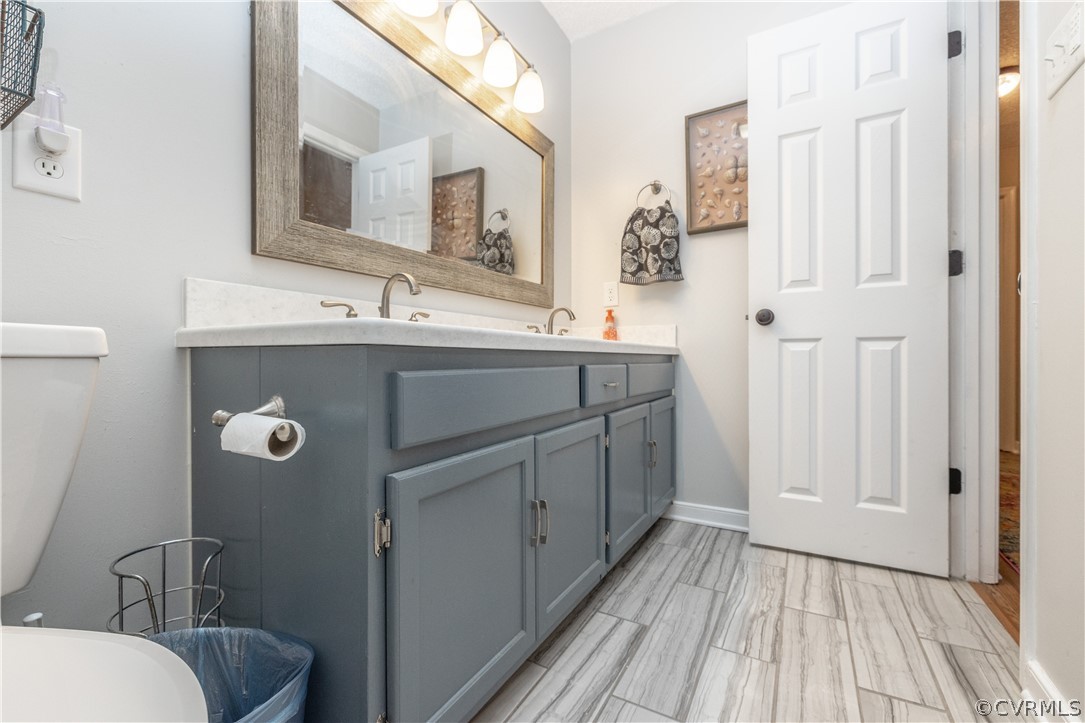 18920 Duval Road Moseley, VA 23120 - Photo 19 of 31 a bathroom with a sink a toilet a mirror and shower