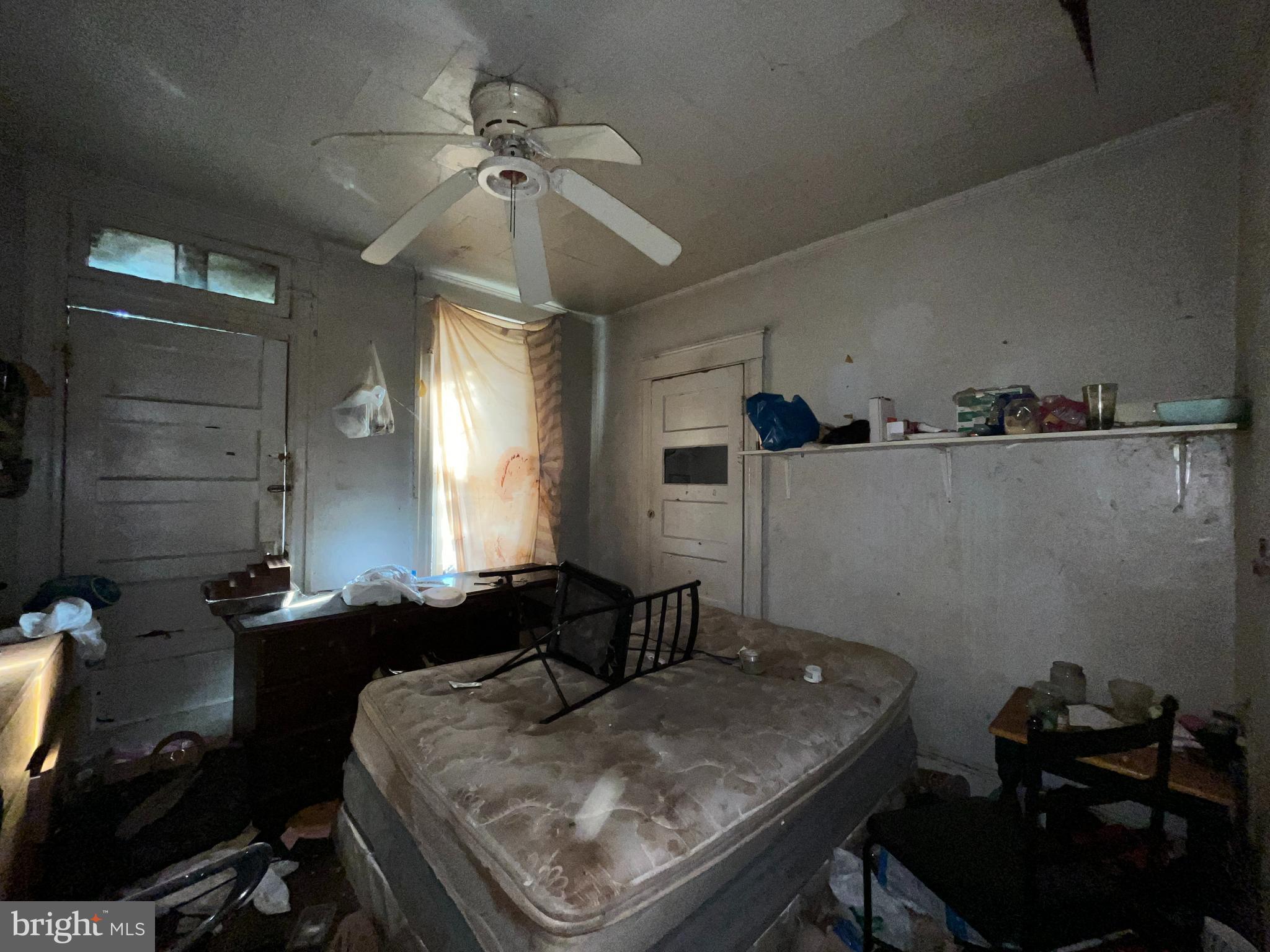 2807 Winchester Street Baltimore, MD 21216 - Photo 15 of 16 a room with a chandelier furniture and a window