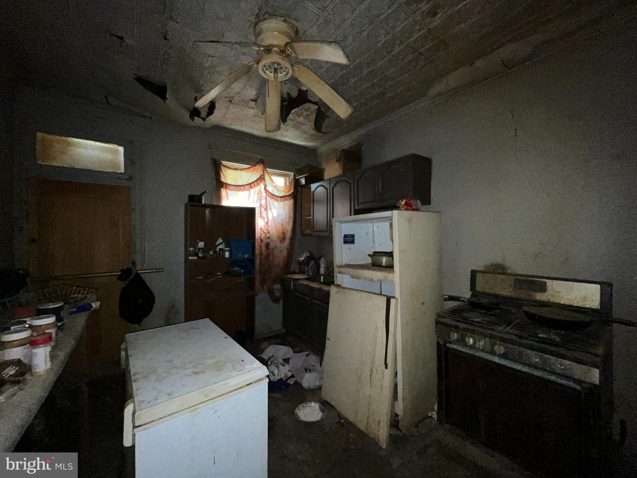 2807 Winchester Street Baltimore, MD 21216 - Photo 7 of 16 a kitchen with a stove and a refrigerator