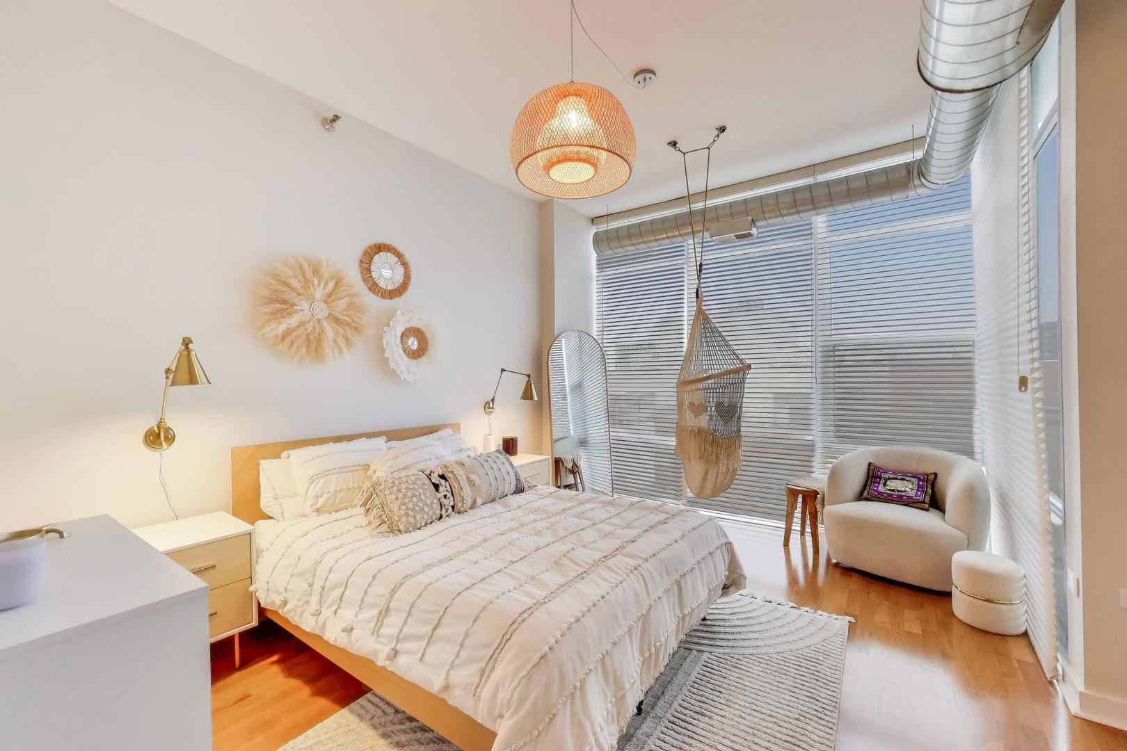 901 West Madison Street, Unit 710 Chicago, IL 60607 - Photo 12 of 35 a bedroom with a bed and a chandelier