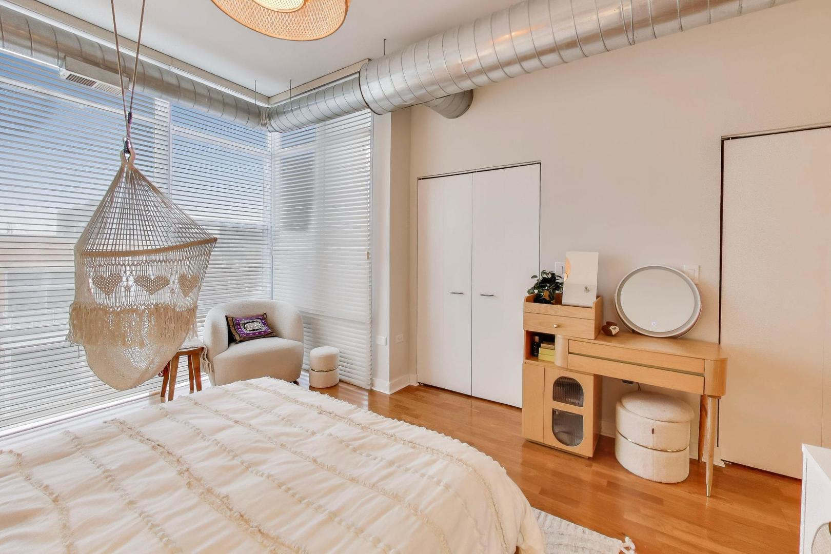 901 West Madison Street, Unit 710 Chicago, IL 60607 - Photo 13 of 35 a bedroom with a bed a mirror and a desk