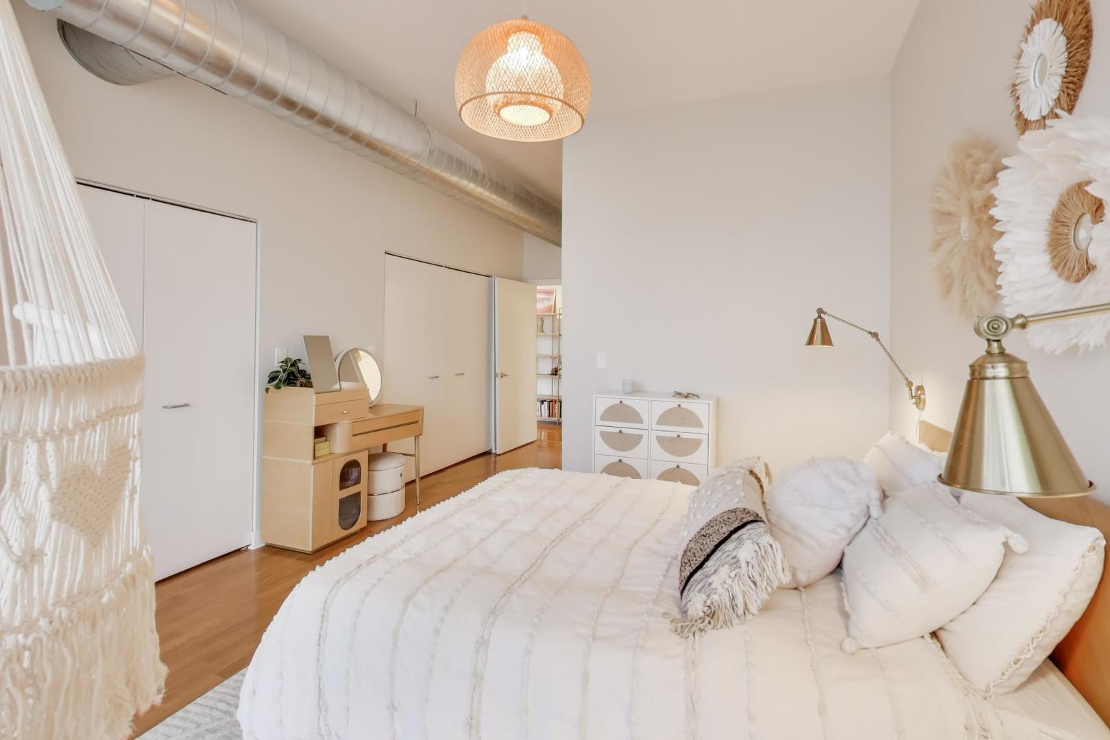 901 West Madison Street, Unit 710 Chicago, IL 60607 - Photo 14 of 35 a bedroom with a bed and a chandelier