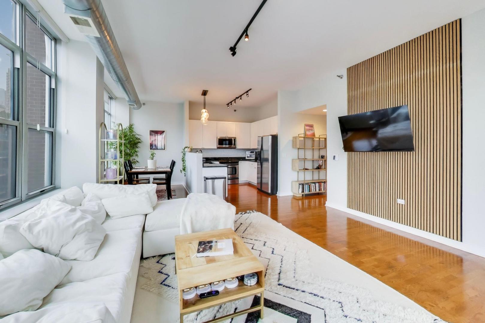 901 West Madison Street, Unit 710 Chicago, IL 60607 - Photo 3 of 35 a living room with furniture and a wooden floor
