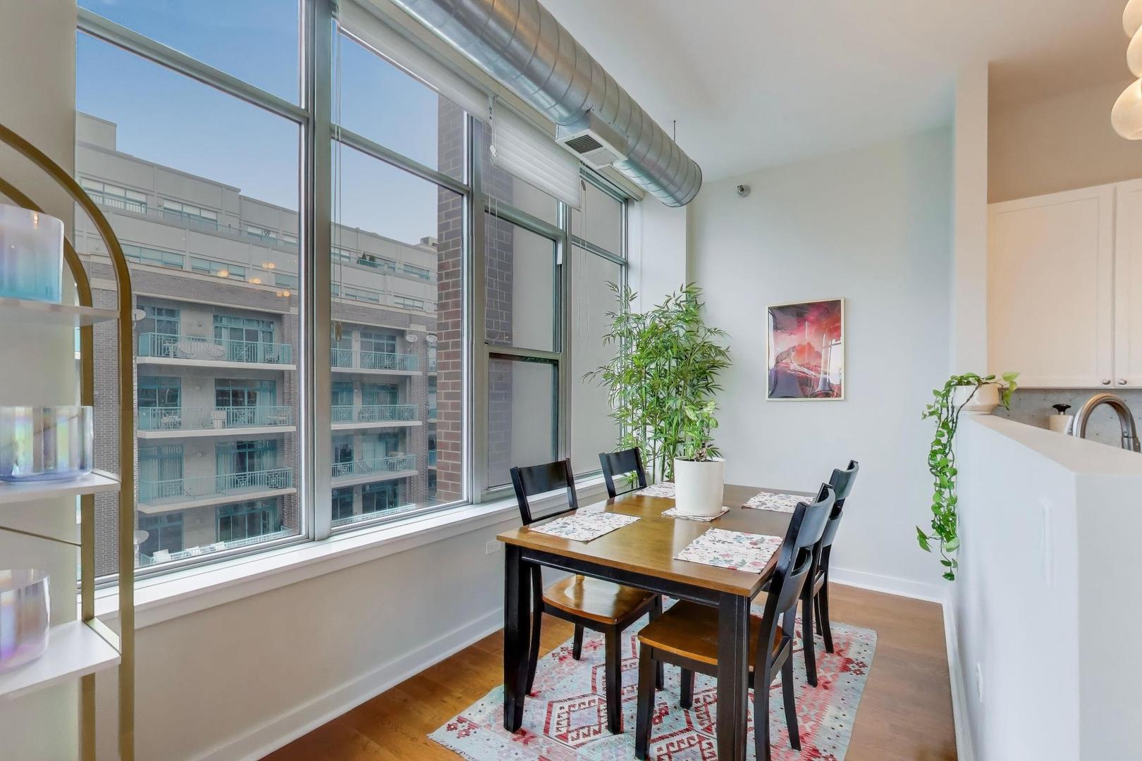 901 West Madison Street, Unit 710 Chicago, IL 60607 - Photo 8 of 35 a view of a dining room with furniture window and wooden floor