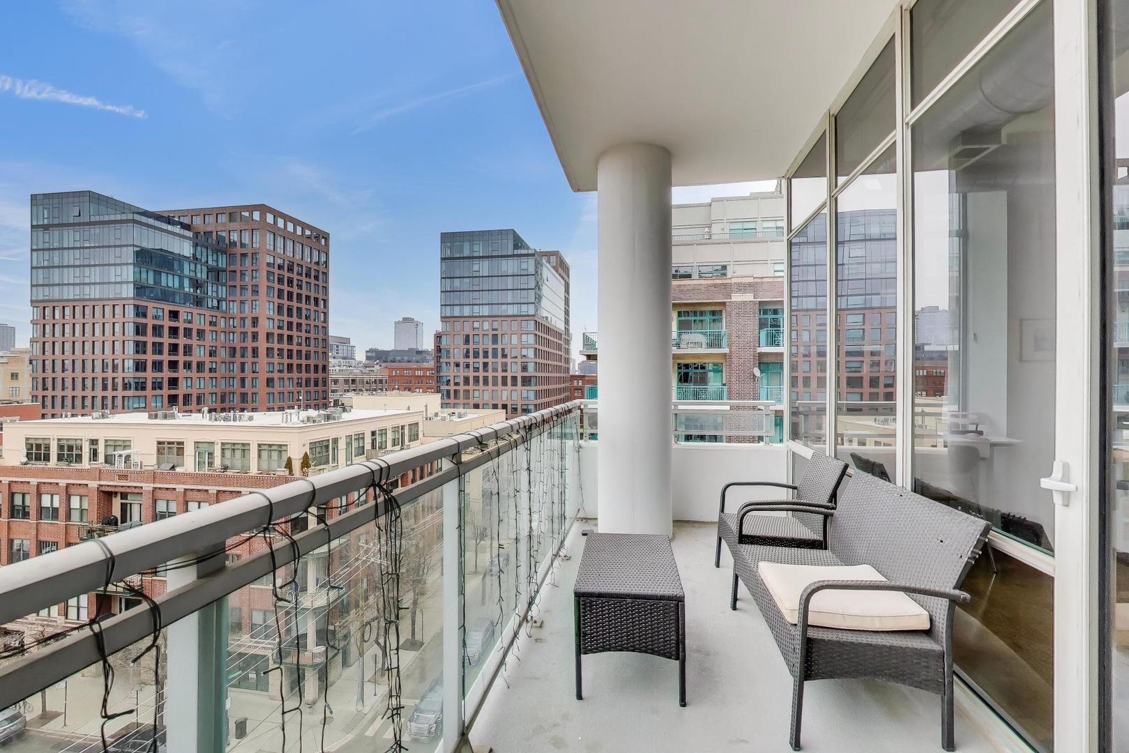 901 West Madison Street, Unit 710 Chicago, IL 60607 - Photo 9 of 35 a balcony with wooden floor and furniture