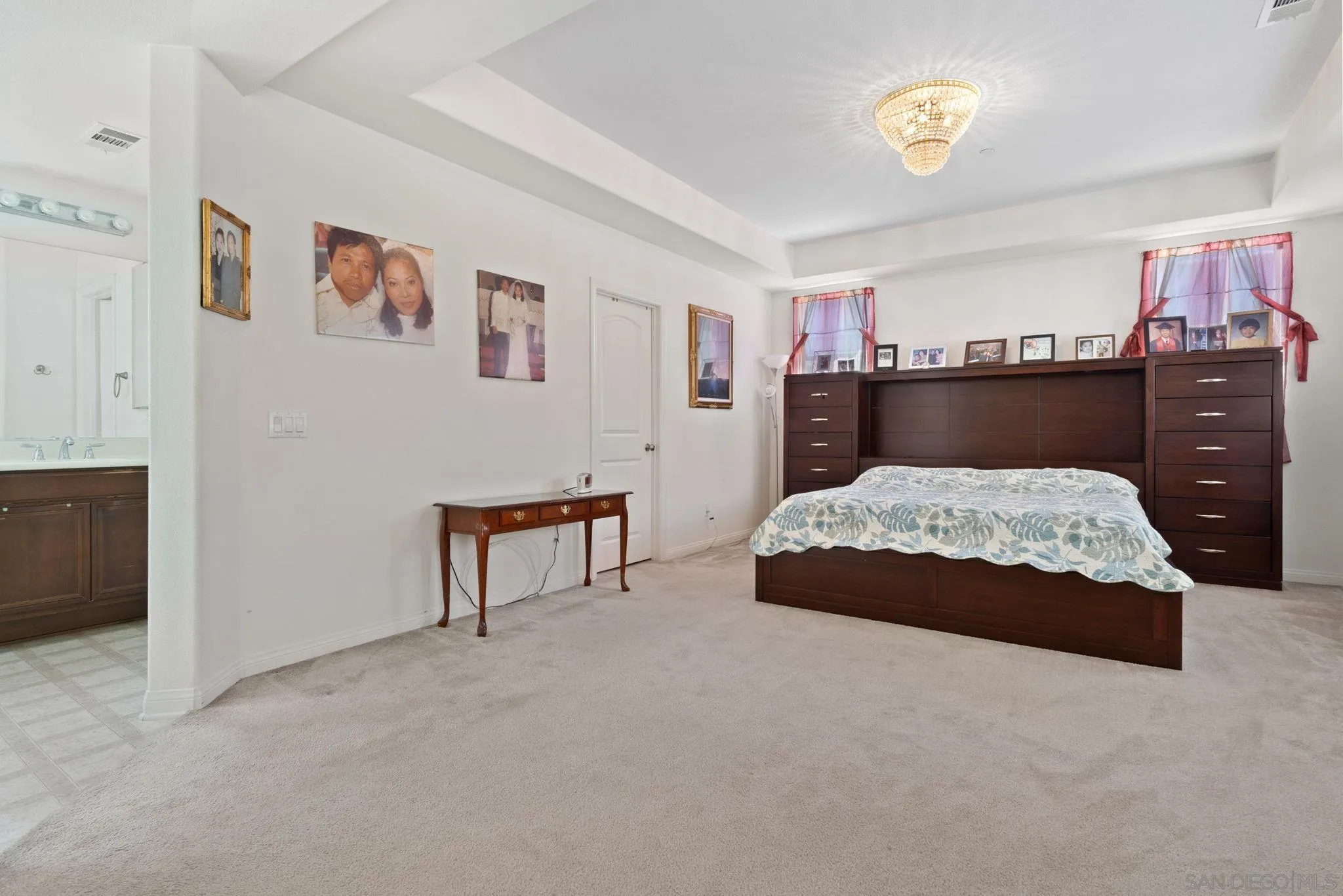 1438 Pershing Road Chula Vista, CA 91913 - Photo 16 of 45 a bedroom with a large bed and a chandelier