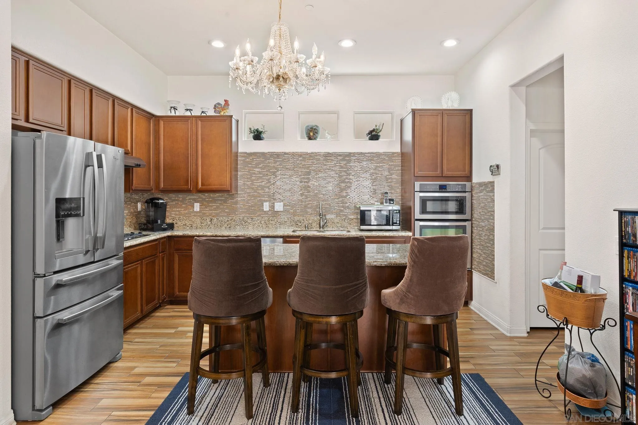 1438 Pershing Road Chula Vista, CA 91913 - Photo 7 of 45 a kitchen with stainless steel appliances granite countertop a table chairs and a refrigerator