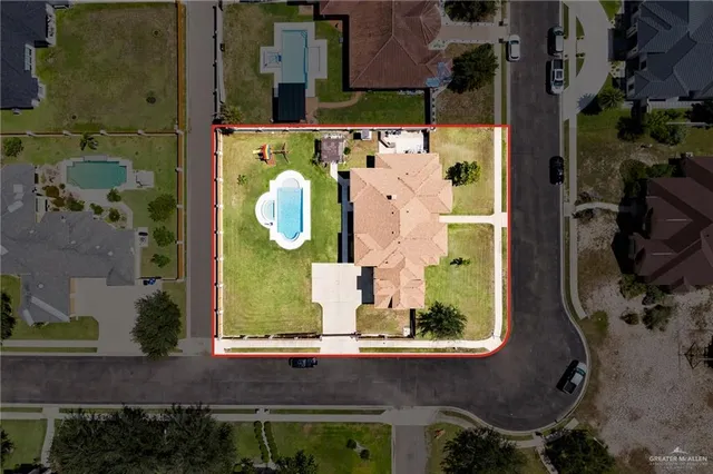 an aerial view of a house with a swimming pool