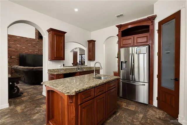 a kitchen with a refrigerator and a sink