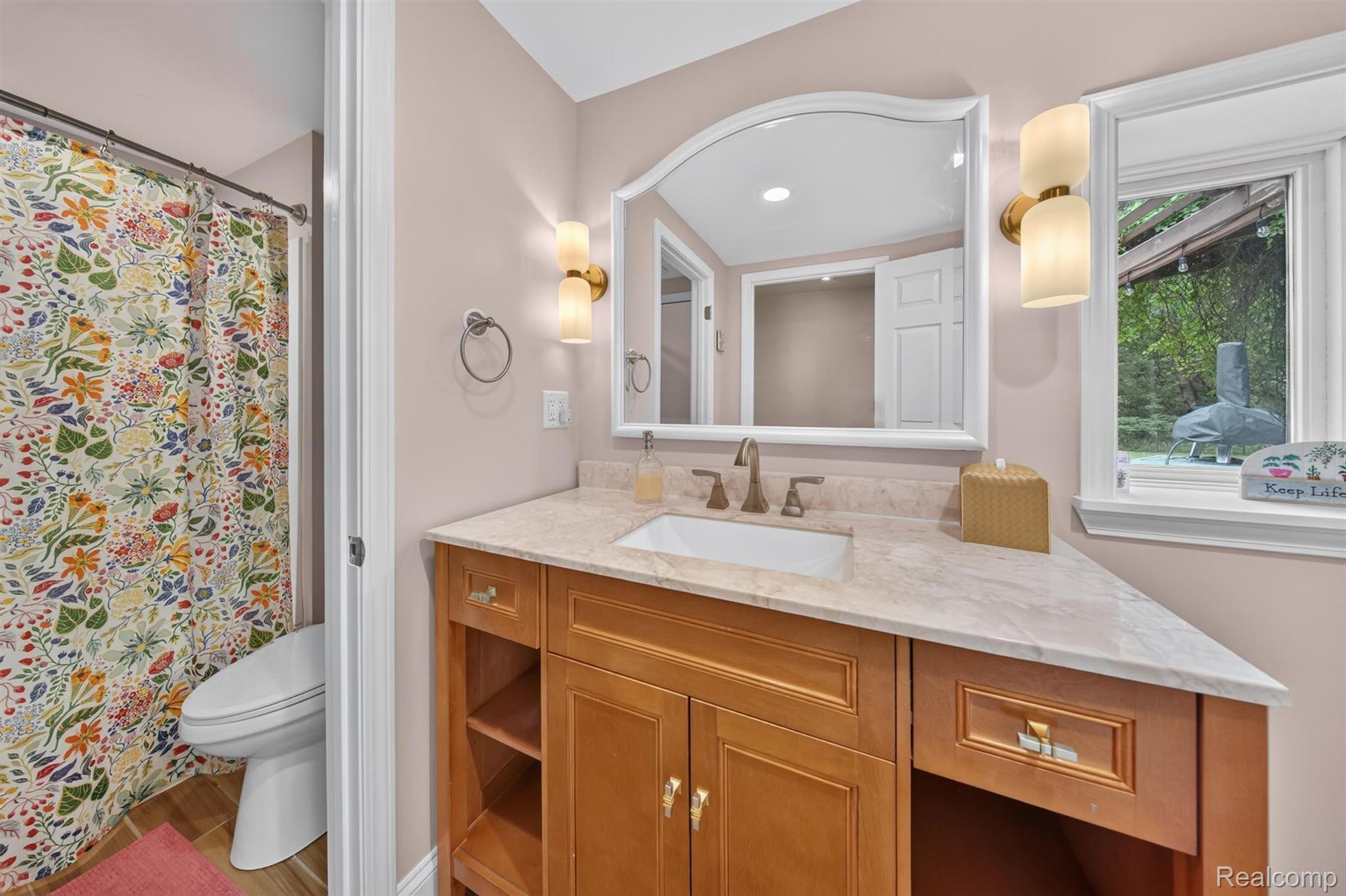 9319 Faussett Road Fenton, MI 48430 - Photo 40 of 70 Wood-finish vanity with an integrated sink and stone countertop