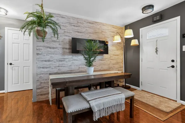 a living room with furniture and a potted plant
