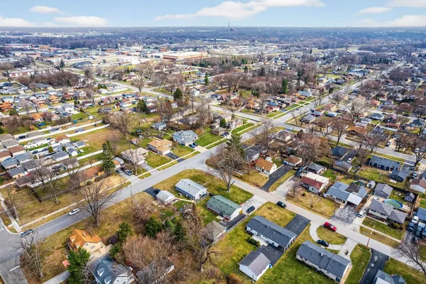 an aerial view of residential houses with outdoor space and seating area