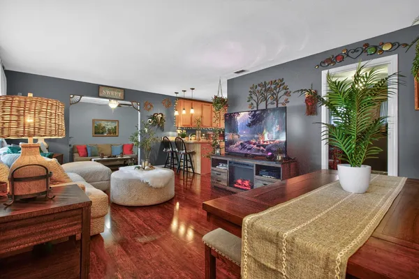 a living room with fireplace furniture and a large window