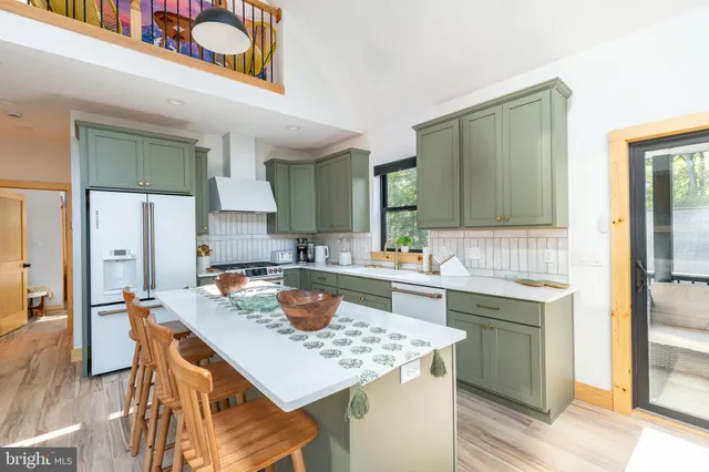 a living room with furniture fireplace and a large window