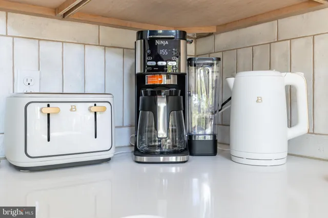 a living room with furniture a rug and a floor to ceiling window
