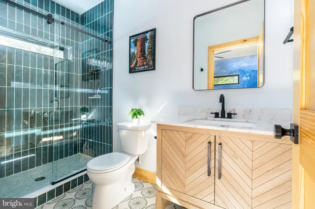 a living room with furniture a flat screen tv and a floor to ceiling window