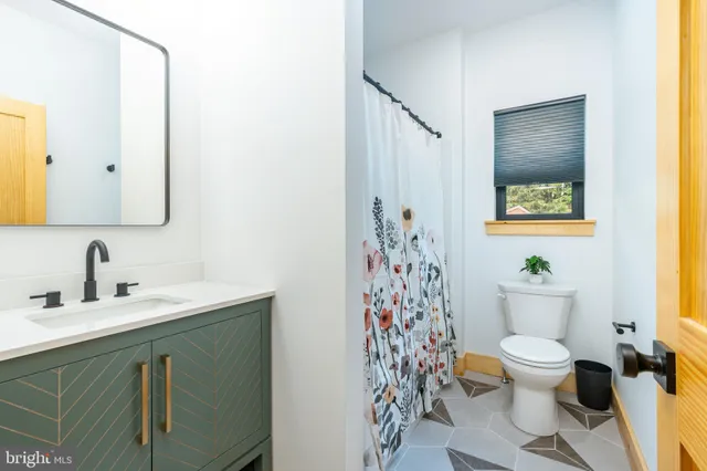 a bathroom with a sink mirror toilet and bathtub