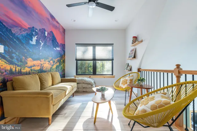 a view of a balcony with chairs and wooden floor