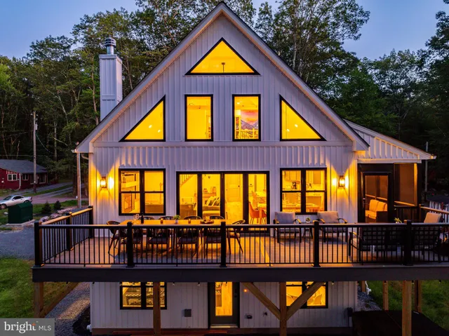 a backyard of a house with yard fire pit and outdoor seating
