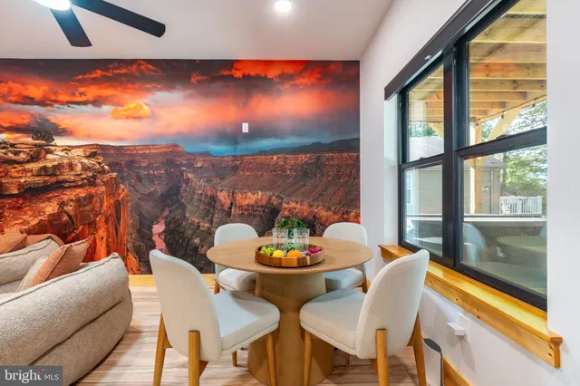 a backyard of a house with fire pit and outdoor seating