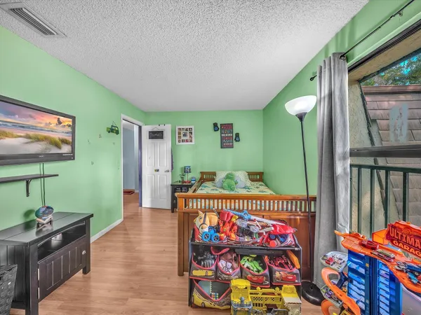 a room with painting on the wall and a flat screen tv