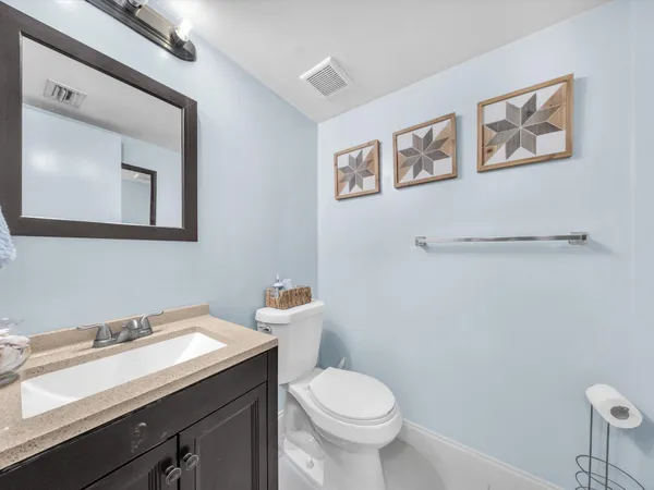 a bathroom with a sink mirror and toilet