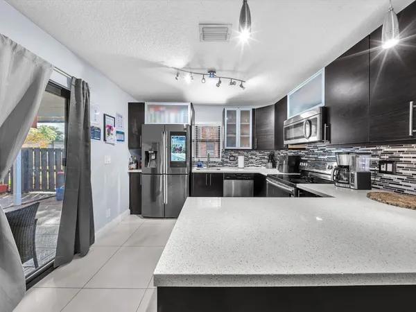 a large kitchen with cabinets and stainless steel appliances