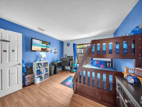 a bedroom with furniture and a book shelf