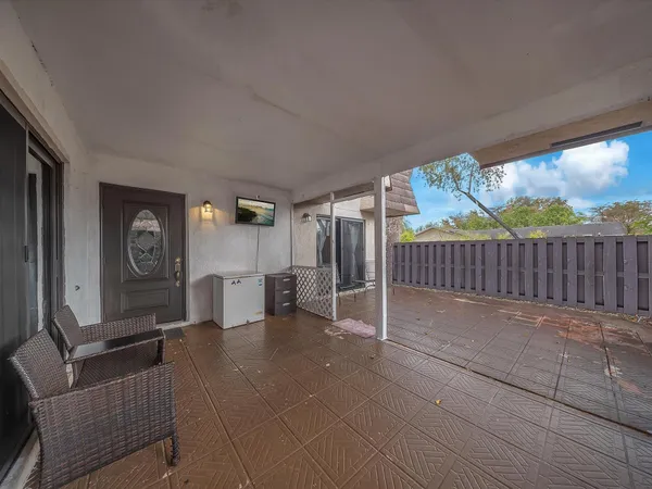 a view of a porch with furniture and garden