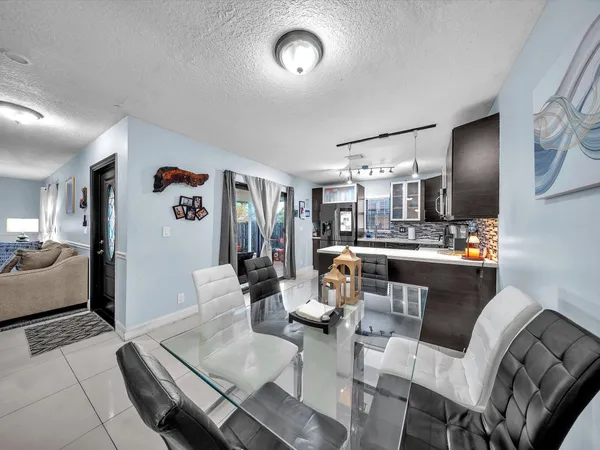 a living room with furniture and kitchen view