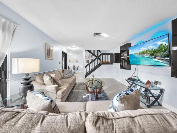a view of a livingroom with furniture and a flat screen tv