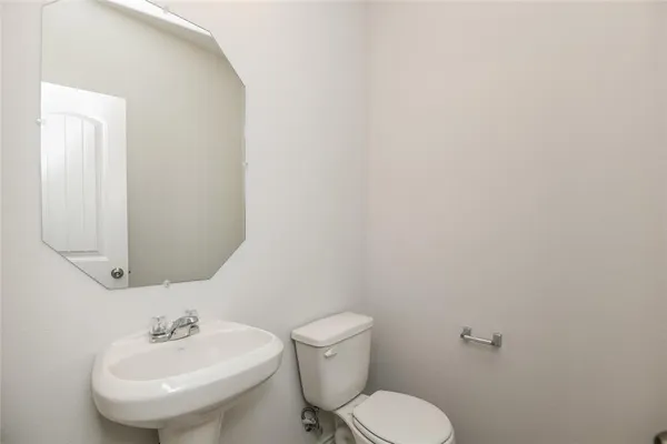a bathroom with a granite countertop sink a toilet and shower