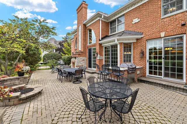 a backyard of a house with table and chairs