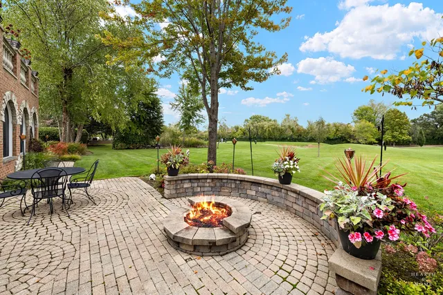 a view of a garden with sitting area
