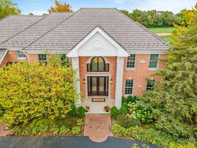 an aerial view of a house with garden space and street view