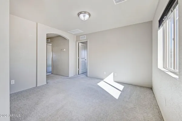 a view of walk in closet with empty racks