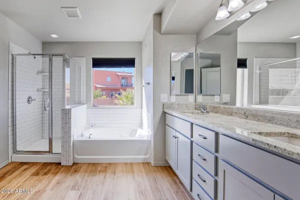 a spacious bathroom with a granite countertop sink vanity and a mirror