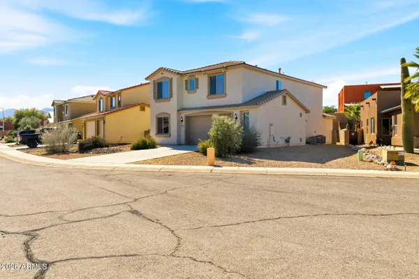 a view of a house with snow on the road