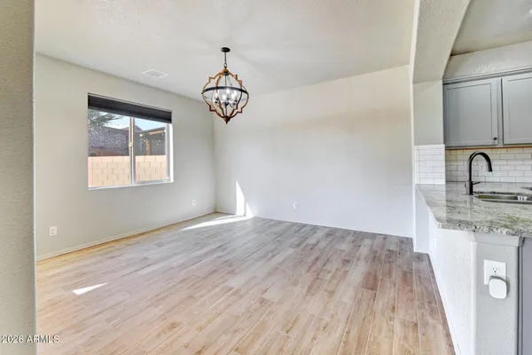 a view of a kitchen with a stove cabinets a ceiling fan and wooden floor