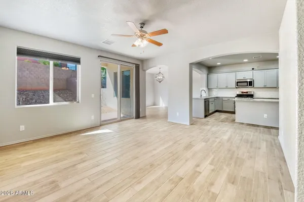 a view of white house with a small yard and wooden floor