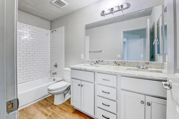 a bathroom with a sink double vanity granite tub and a mirror