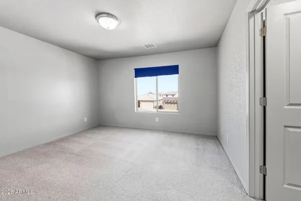 an empty room with windows and closet