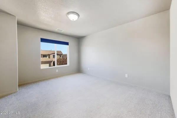 an empty room with closet and a bathroom