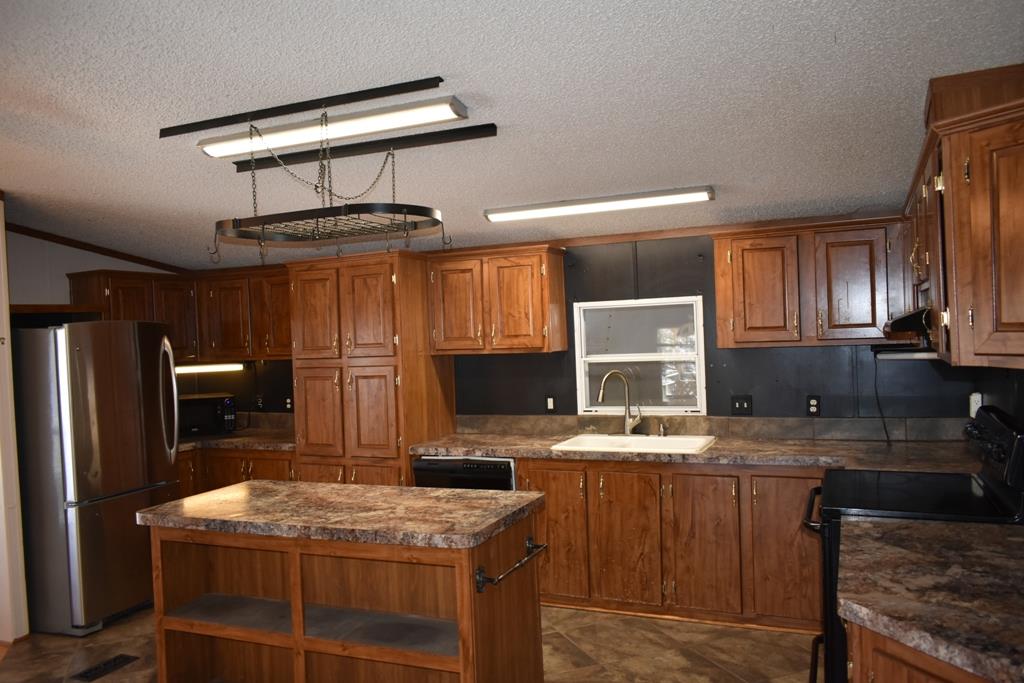 89 Dog Branch Road Pleasant Shade, TN 37145 - Photo 4 of 11 a kitchen with kitchen island granite countertop a sink stove and refrigerator