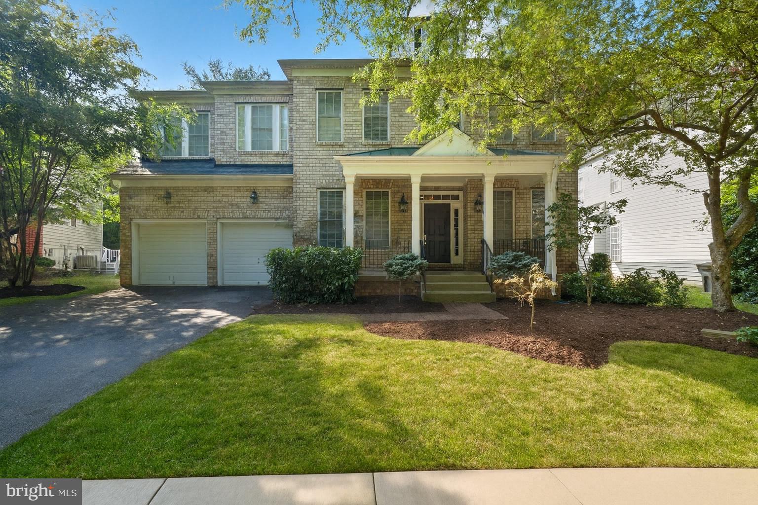 a front view of a house with a yard and porch